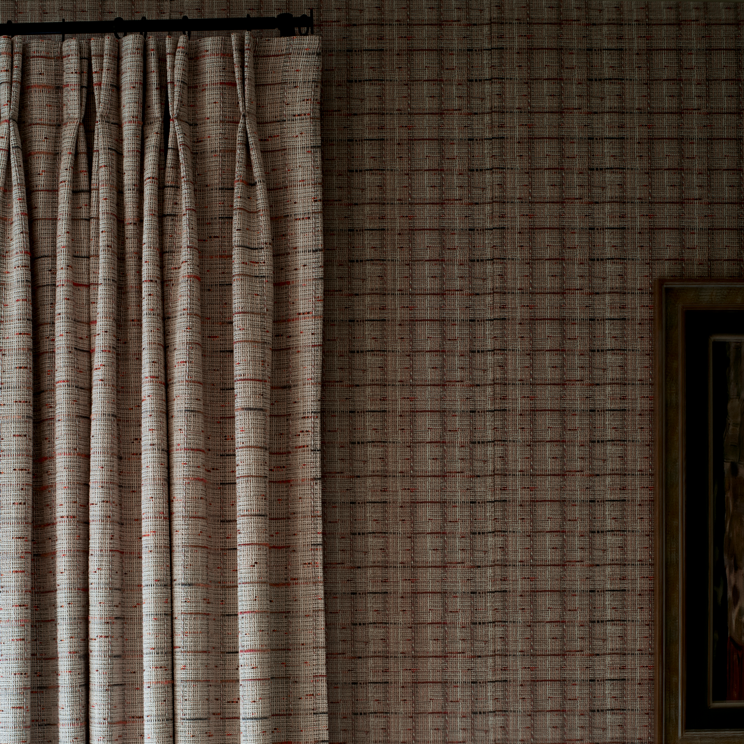 A close-up of a pleated curtain panel hanging on a dark rod against a matching patterned wallpaper with a subtle grid design.